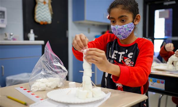 Girl builds marshmallow tower